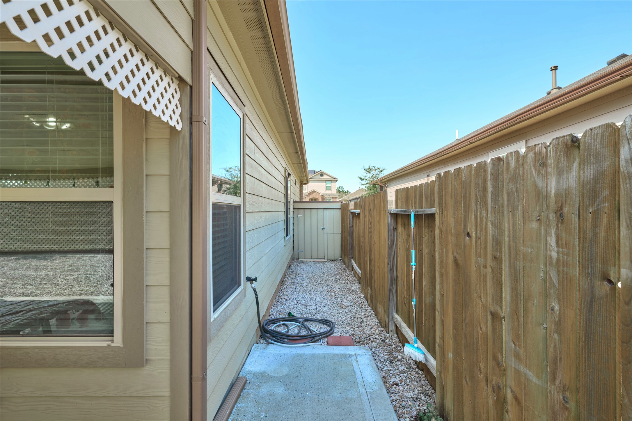 2020 Cedar Tree Court Conroe, TX 77301 - Photo 23 of 26 Close up view of side of home & storage shed