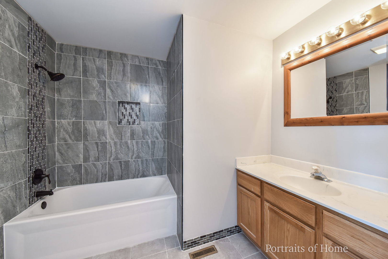 235 Rollin Road, Unit C Somonauk, IL 60552 - Photo 11 of 20 a bathroom with a bathtub a sink a vanity and a shower