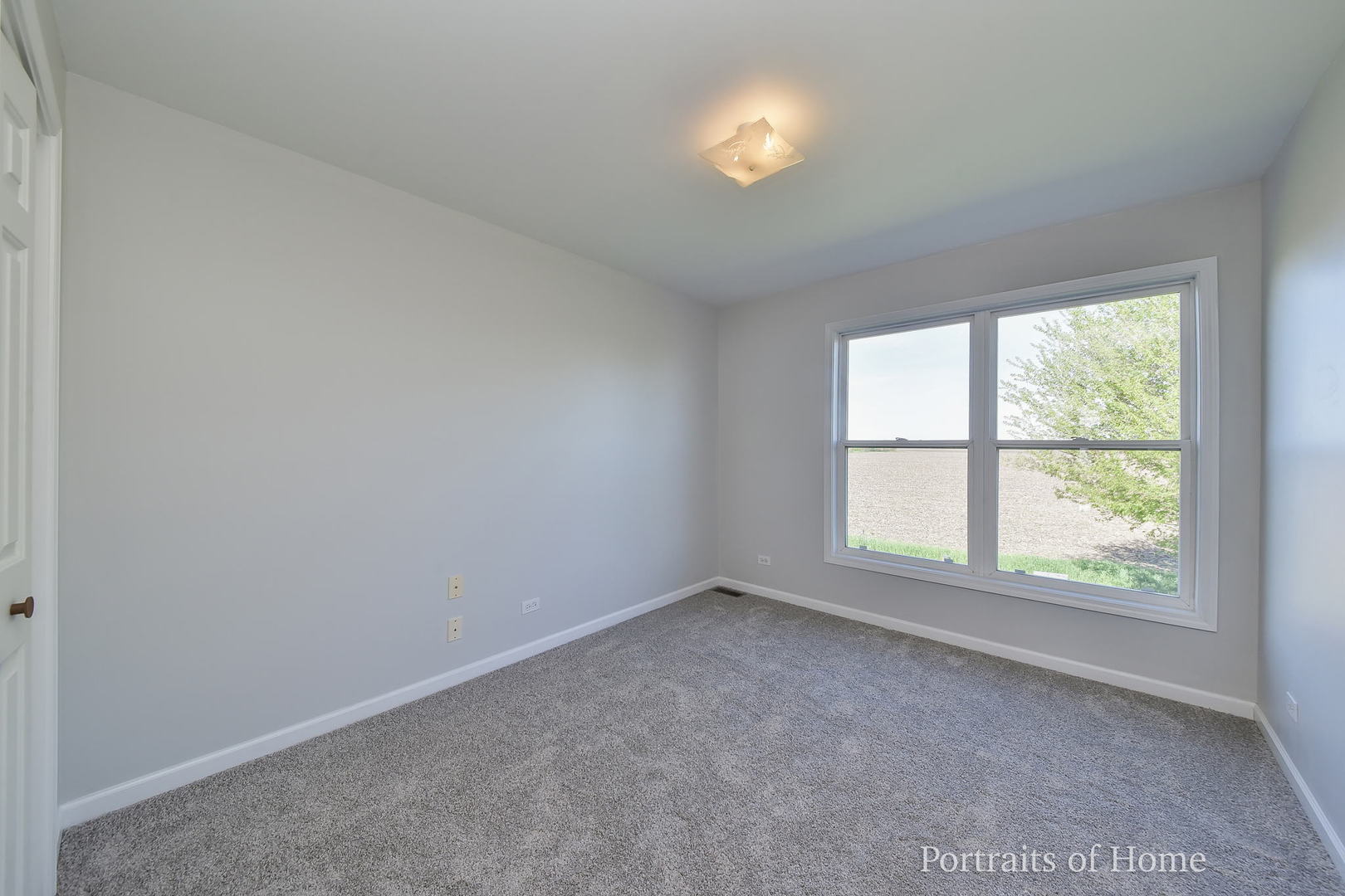 235 Rollin Road, Unit C Somonauk, IL 60552 - Photo 13 of 20 an empty room with a window