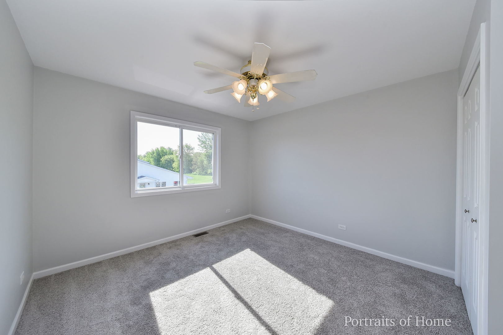 235 Rollin Road, Unit C Somonauk, IL 60552 - Photo 14 of 20 an empty room with windows and ceiling fan