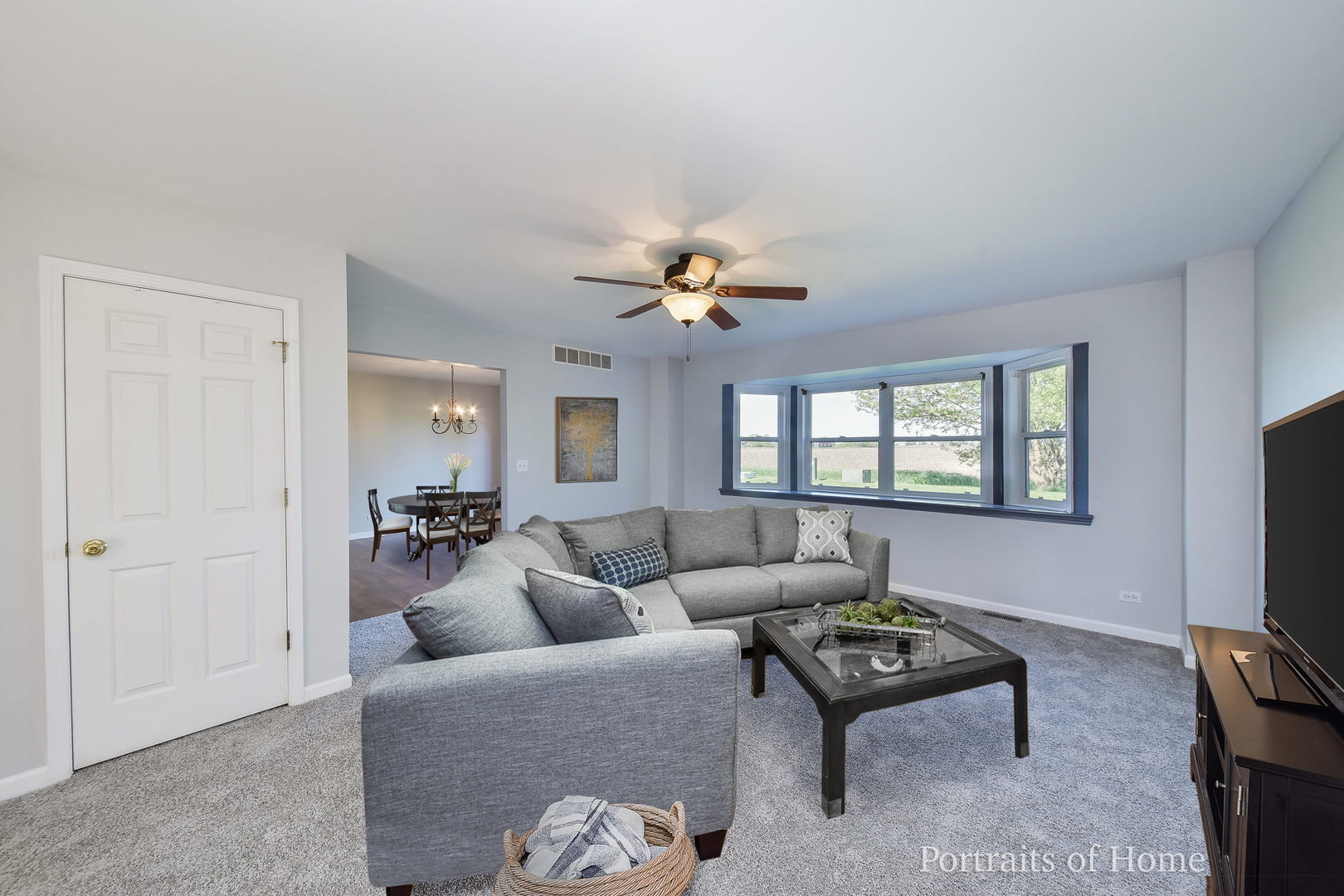 235 Rollin Road, Unit C Somonauk, IL 60552 - Photo 2 of 20 a living room with furniture a flat screen tv and a window