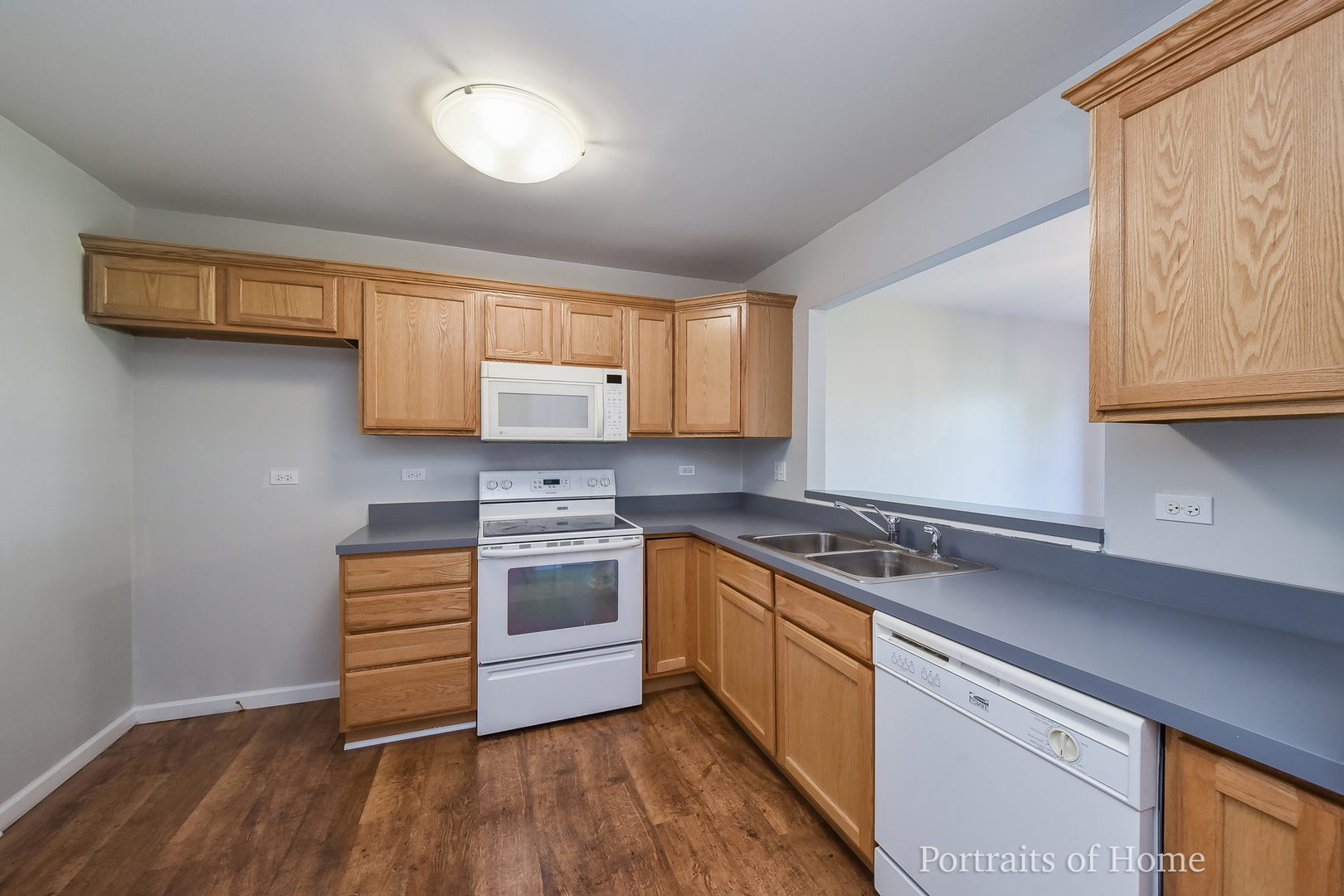 235 Rollin Road, Unit C Somonauk, IL 60552 - Photo 7 of 20 a kitchen with stainless steel appliances granite countertop a stove and a sink