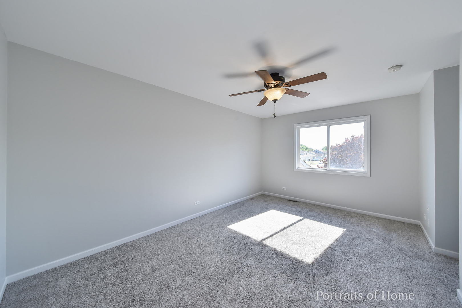 235 Rollin Road, Unit C Somonauk, IL 60552 - Photo 10 of 20 an empty room with windows and fan