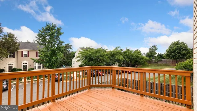 a balcony with wooden floor and fence