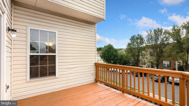 a view of a balcony with wooden floor and fence