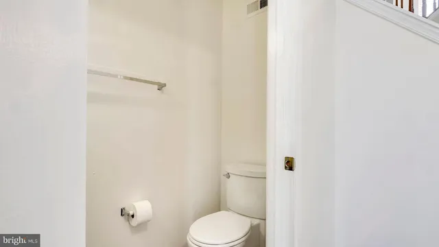 a white toilet sitting next to a shower