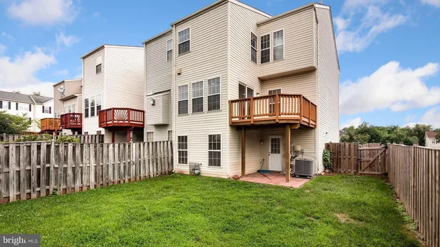 a view of a house with a wooden fence