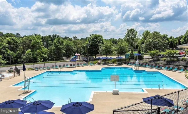 a view of a swimming pool with an outdoor seating