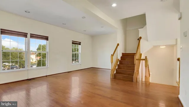 a view of an entryway with wooden floor and windows