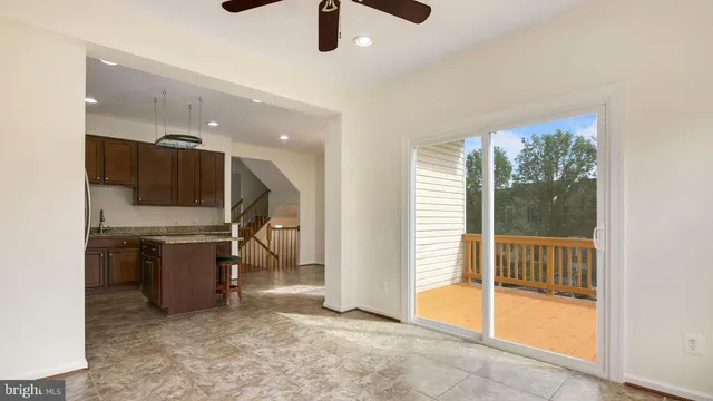 a view of an empty room with a kitchen