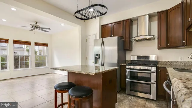 a kitchen with stainless steel appliances granite countertop a stove and a refrigerator