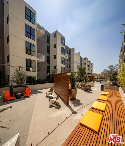 a roof deck with a table and chairs