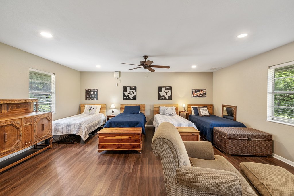 23644 Nameless Road Leander, TX 78641 - Photo 23 of 40 Hardwood floors and generous natural light elevate this spacious sleeping area.