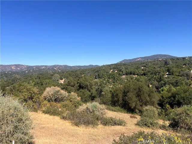 a view of a mountain range in a cloudy sky