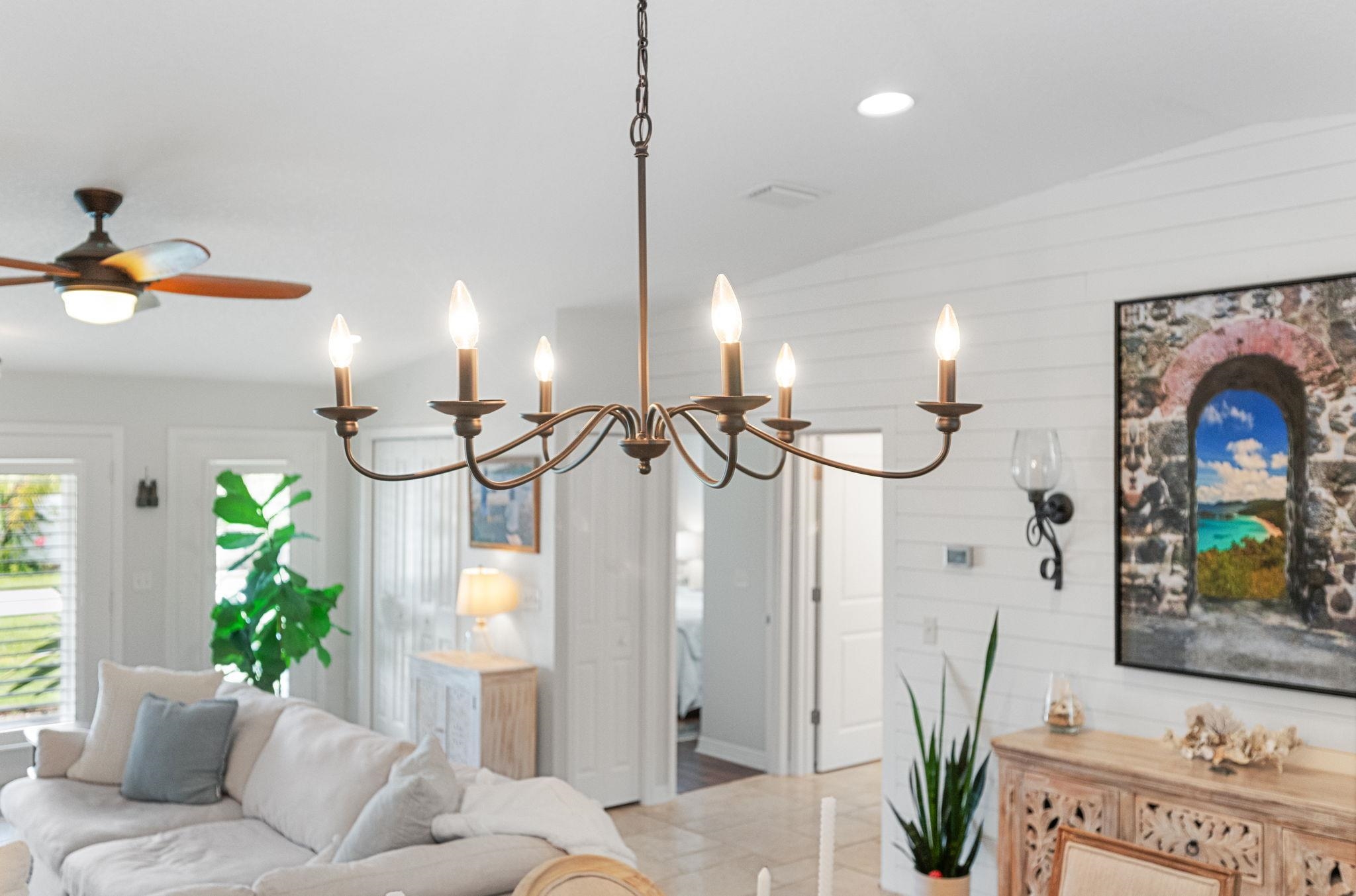 305 Mystical Way St. Augustine, FL 32080 - Photo 22 of 96 a living room with furniture a potted plant and a chandelier