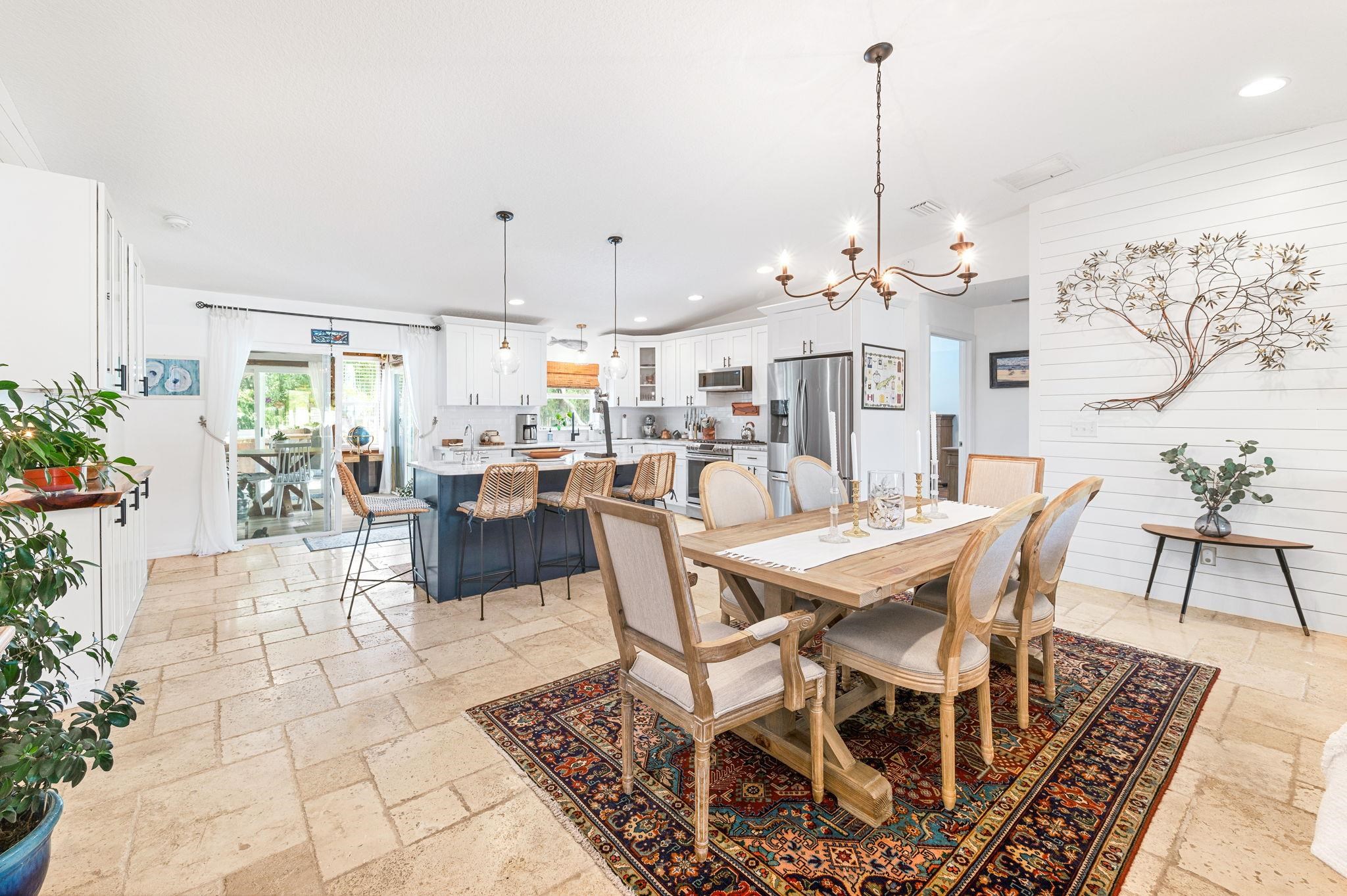 305 Mystical Way St. Augustine, FL 32080 - Photo 23 of 96 a view of a dining room and livingroom with furniture wooden floor a chandelier and a rug
