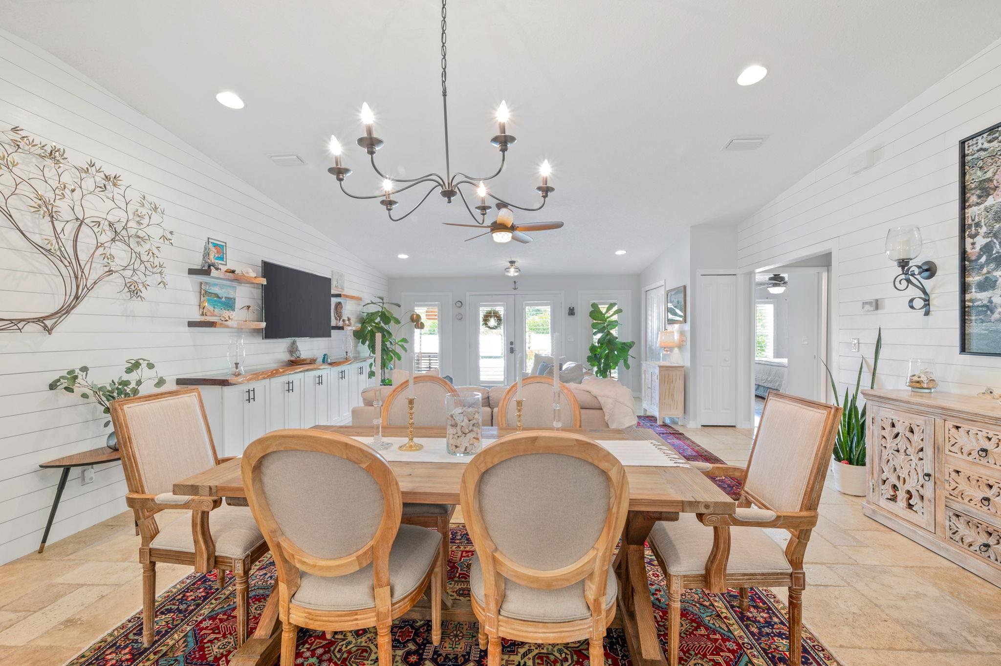 305 Mystical Way St. Augustine, FL 32080 - Photo 24 of 96 a dining room with wooden floor a chandelier a wooden table and chairs