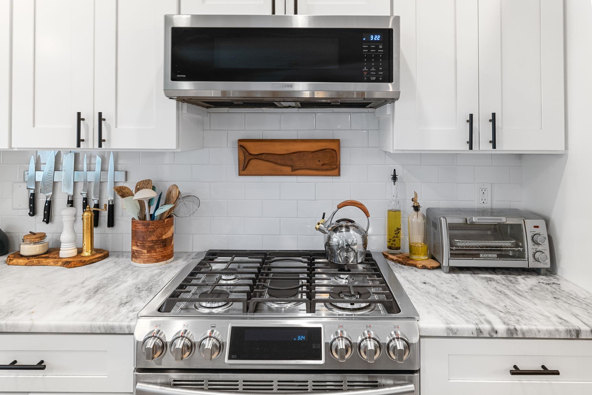 305 Mystical Way St. Augustine, FL 32080 - Photo 32 of 96 a kitchen with stainless steel appliances granite countertop a stove and a microwave