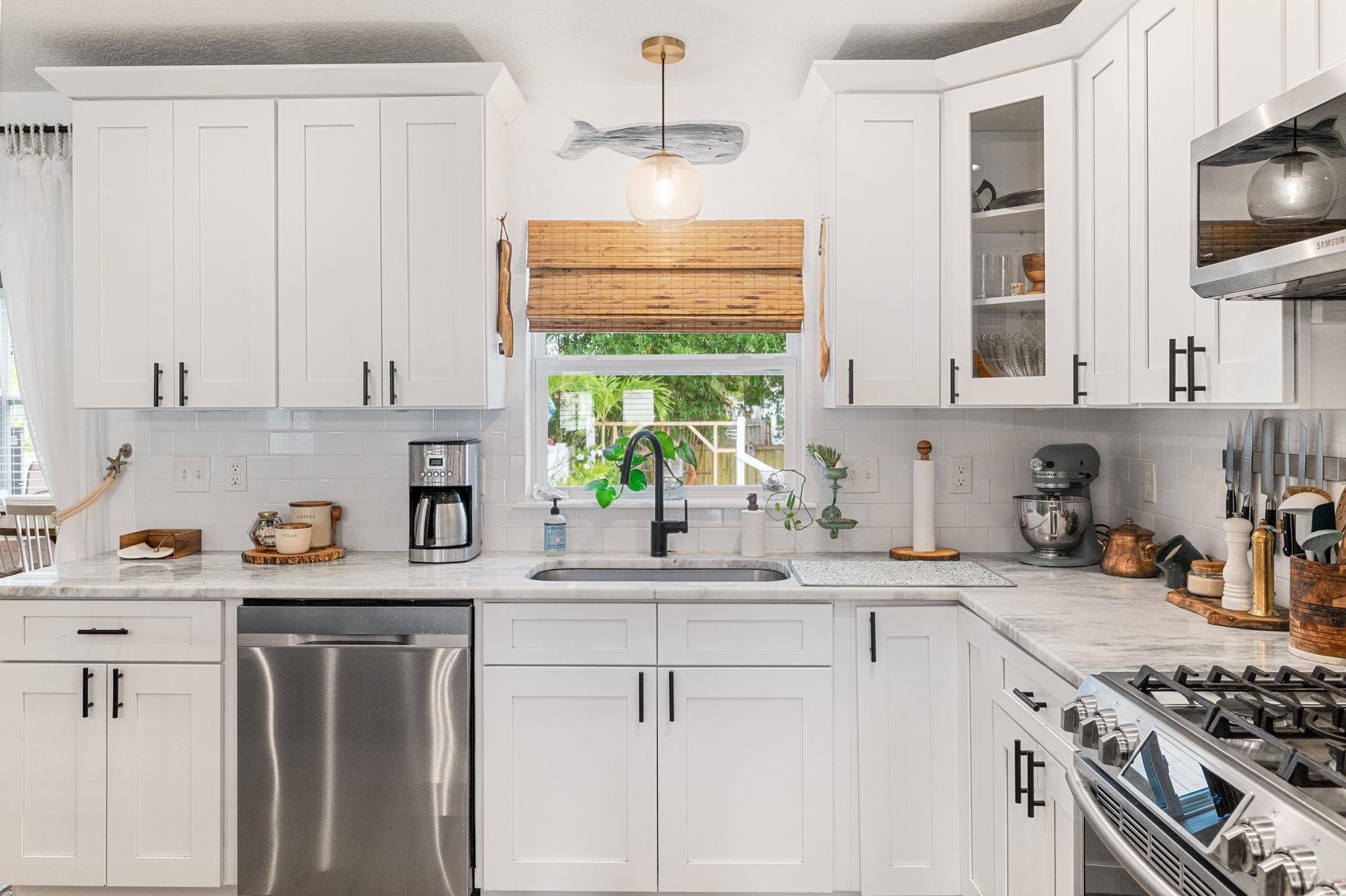 305 Mystical Way St. Augustine, FL 32080 - Photo 33 of 96 a kitchen with stainless steel appliances a sink a stove a window and cabinets