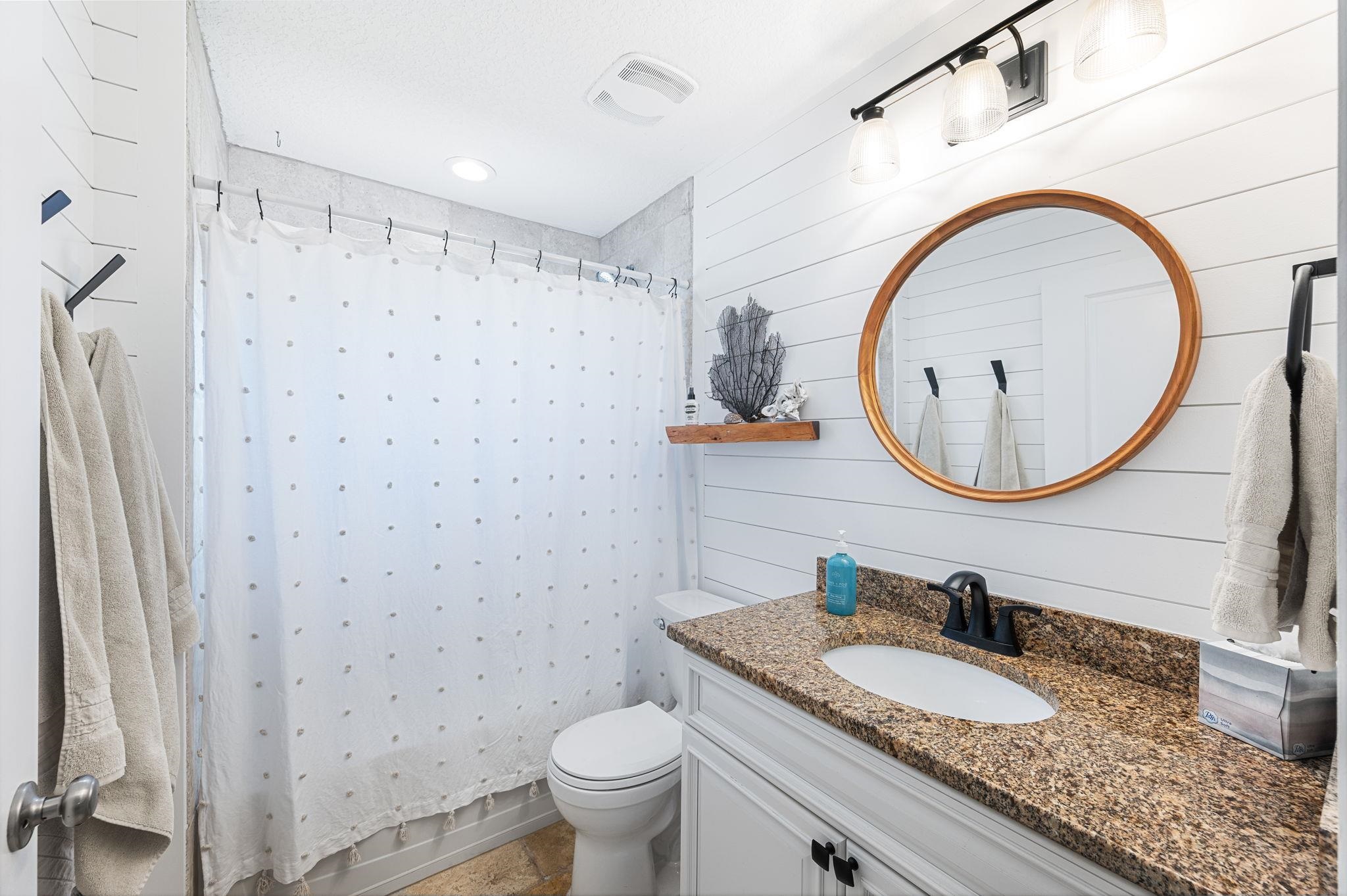 305 Mystical Way St. Augustine, FL 32080 - Photo 41 of 96 a bathroom with a granite countertop toilet a sink and a mirror
