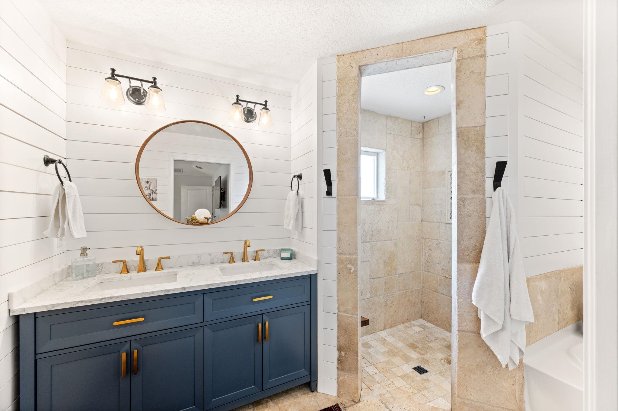 305 Mystical Way St. Augustine, FL 32080 - Photo 52 of 96 a bathroom with a granite countertop sink a mirror and a shower