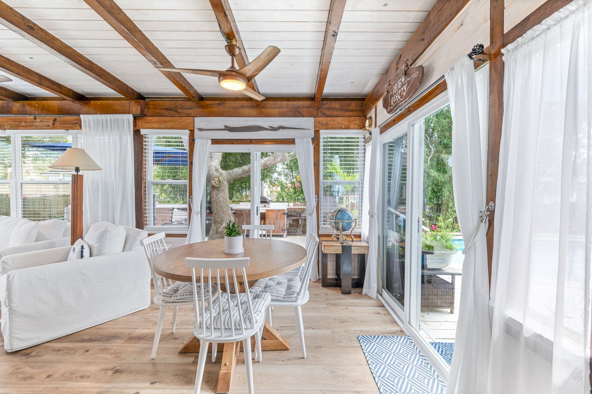 305 Mystical Way St. Augustine, FL 32080 - Photo 55 of 96 a dining room with furniture a chandelier and glass door