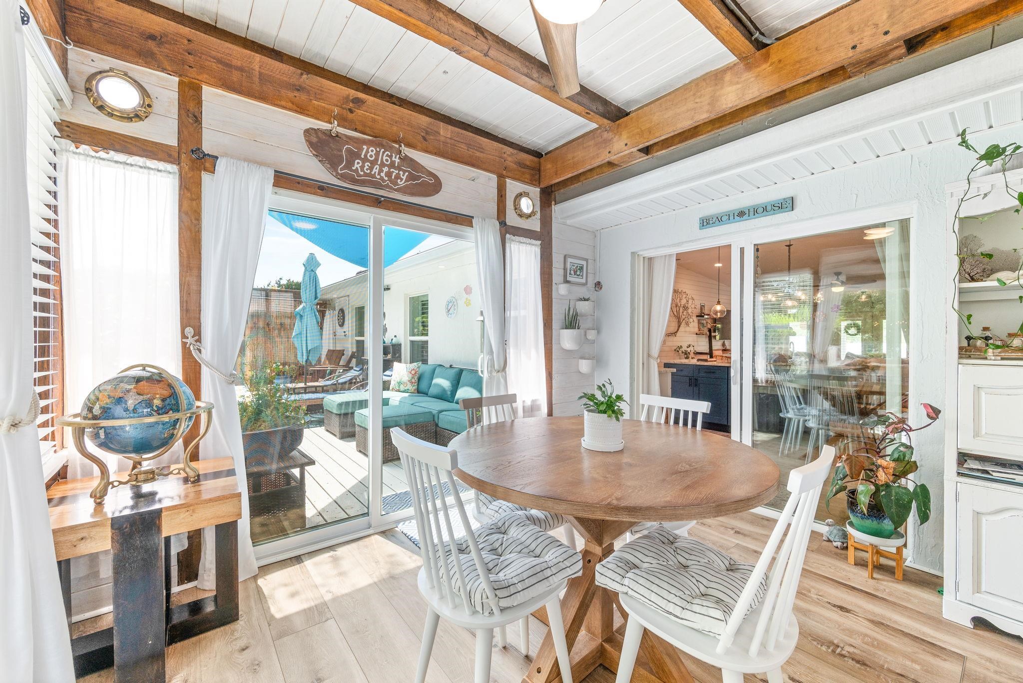 305 Mystical Way St. Augustine, FL 32080 - Photo 56 of 96 a view of a dining room with furniture wooden floor and a chandelier