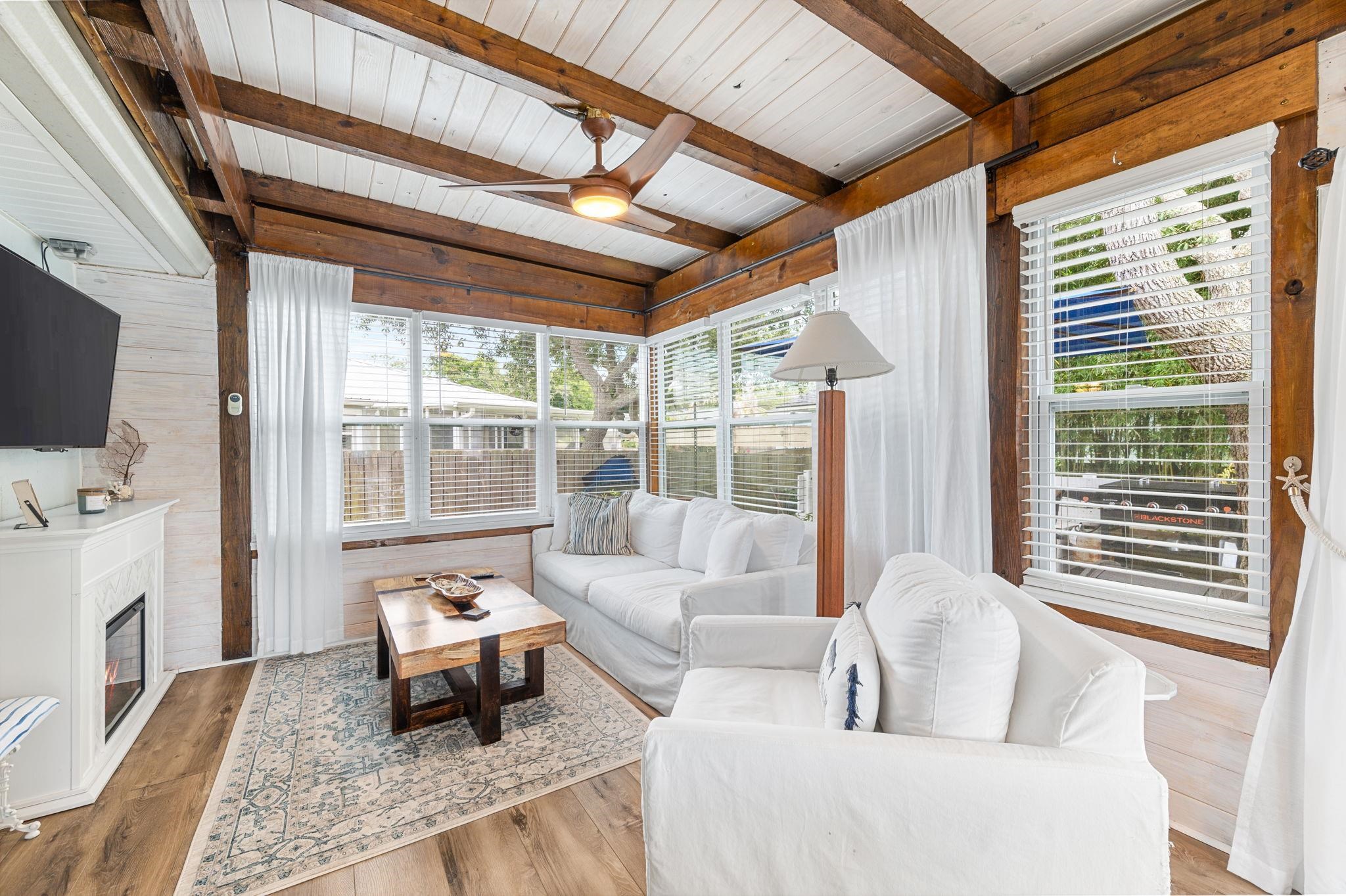 305 Mystical Way St. Augustine, FL 32080 - Photo 61 of 96 a living room with furniture a flat screen tv and a floor to ceiling window