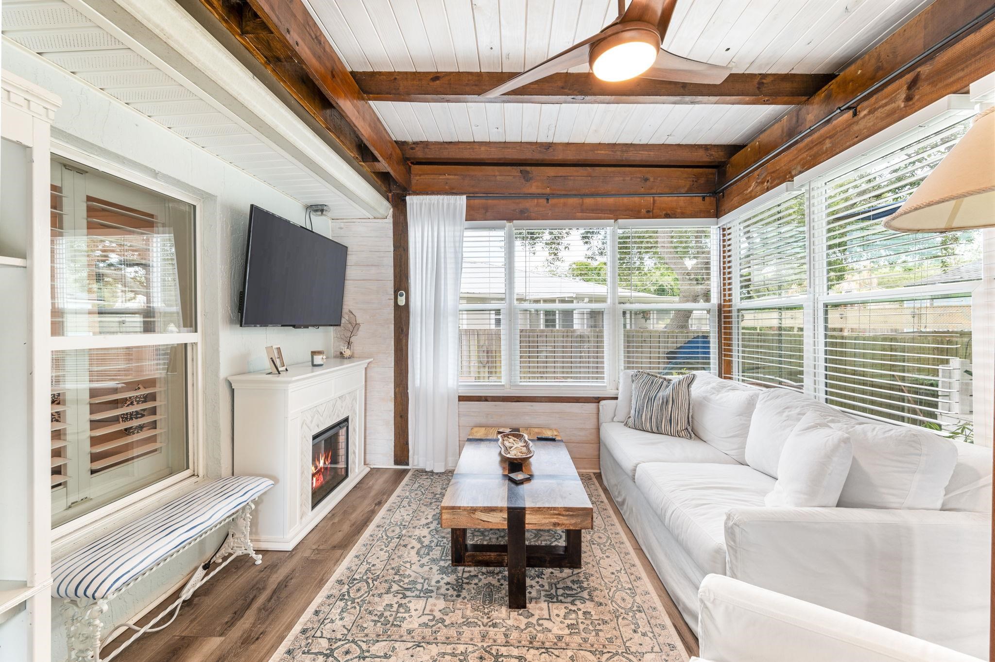 305 Mystical Way St. Augustine, FL 32080 - Photo 62 of 96 a living room with furniture a flat screen tv and a fireplace