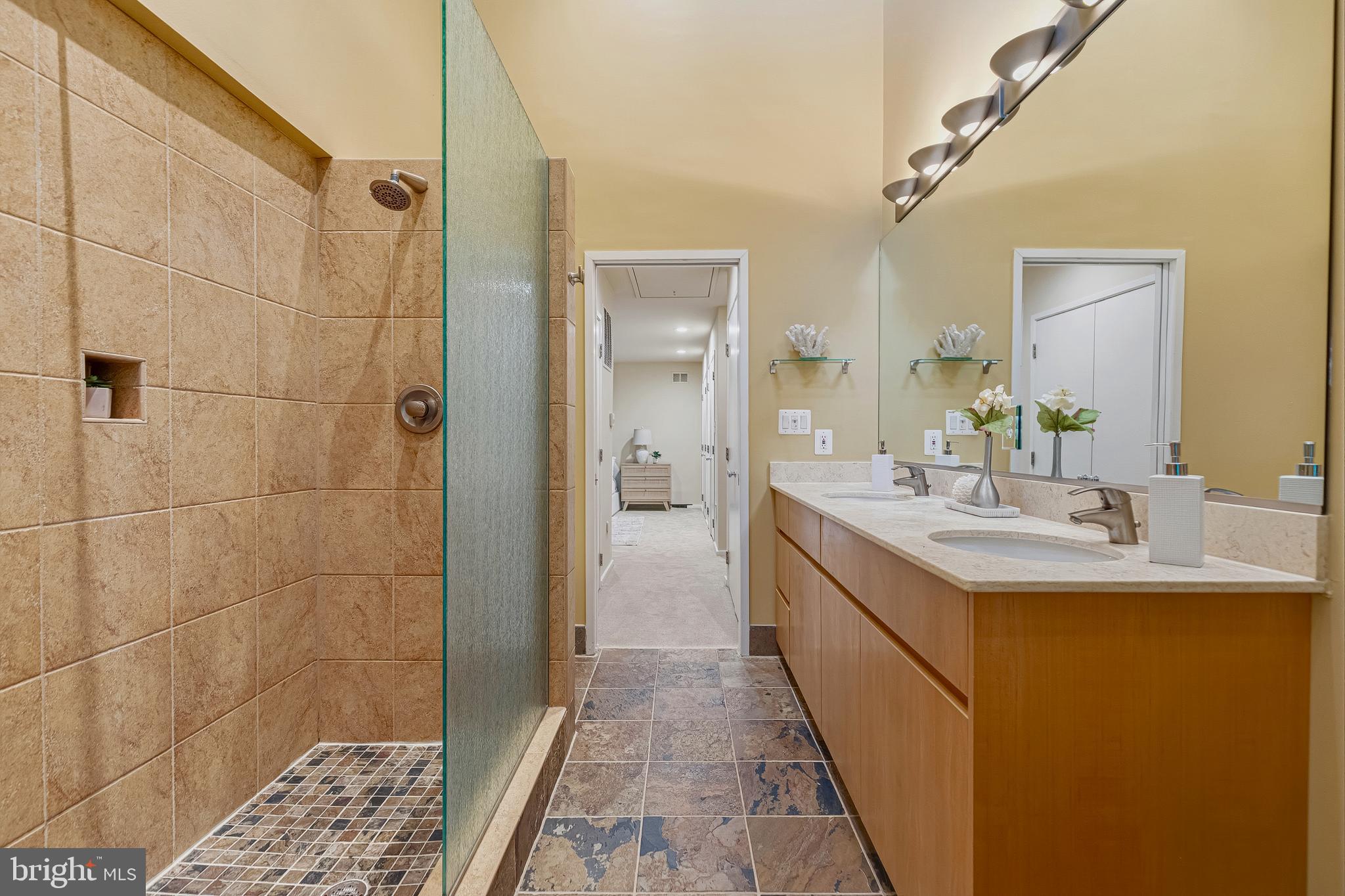 5196 27th Street Northwest Washington, DC 20008 - Photo 43 of 68 a bathroom with a double vanity sink a toilet and shower