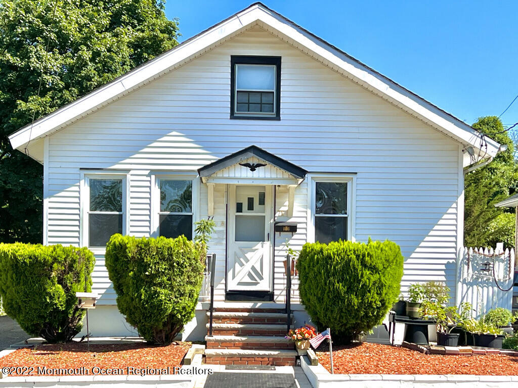 71 White Road Shrewsbury, NJ 07702 - Photo 1 of 26 a view of a house with brick walls and a flower garden