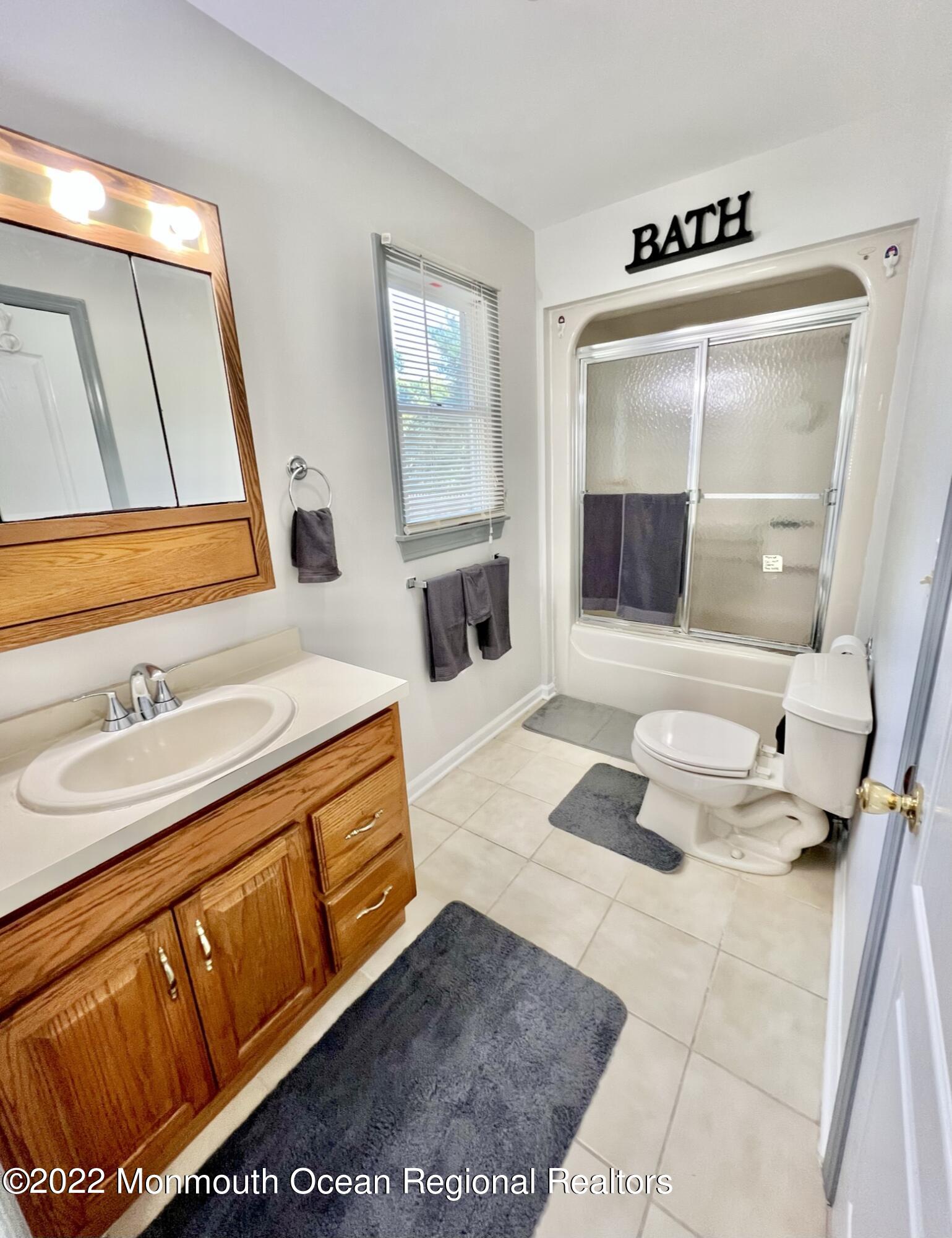 71 White Road Shrewsbury, NJ 07702 - Photo 17 of 26 a bathroom with a sink a mirror and a shower