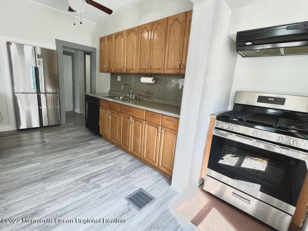 71 White Road Shrewsbury, NJ 07702 - Photo 10 of 26 a kitchen with stainless steel appliances granite countertop a refrigerator stove and sink