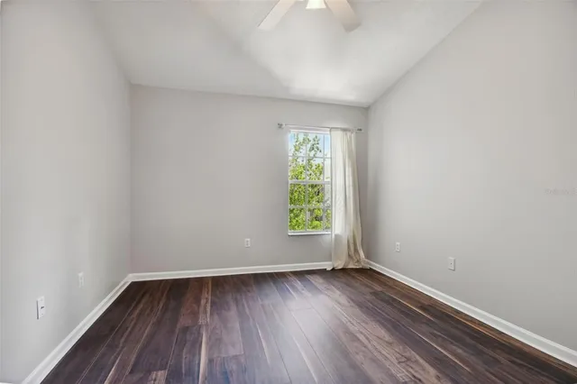 a view of a room with wooden floor and white walls
