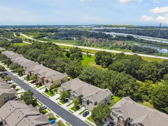 an aerial view of a house with a yard swimming pool outdoor seating and yard