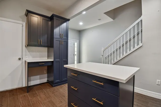 a kitchen with a sink cabinets appliances and a window