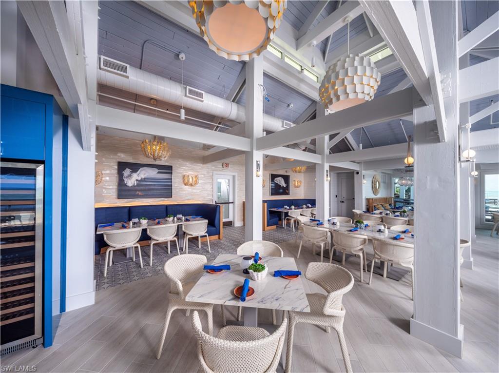6549 Marissa Loop, Unit 15 Naples, FL 34108 - Photo 19 of 24 a view of a dining room with furniture wooden floor and chandelier