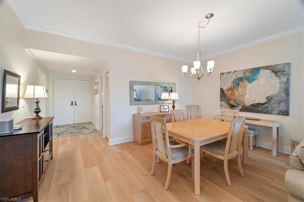 6549 Marissa Loop, Unit 15 Naples, FL 34108 - Photo 4 of 24 a view of a dining room with furniture window and wooden floor