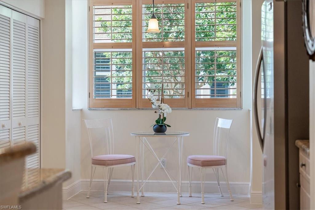 6549 Marissa Loop, Unit 15 Naples, FL 34108 - Photo 7 of 24 a table with a chair and a table