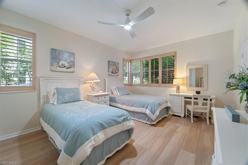 6549 Marissa Loop, Unit 15 Naples, FL 34108 - Photo 10 of 24 a spacious bedroom with two beds and a table