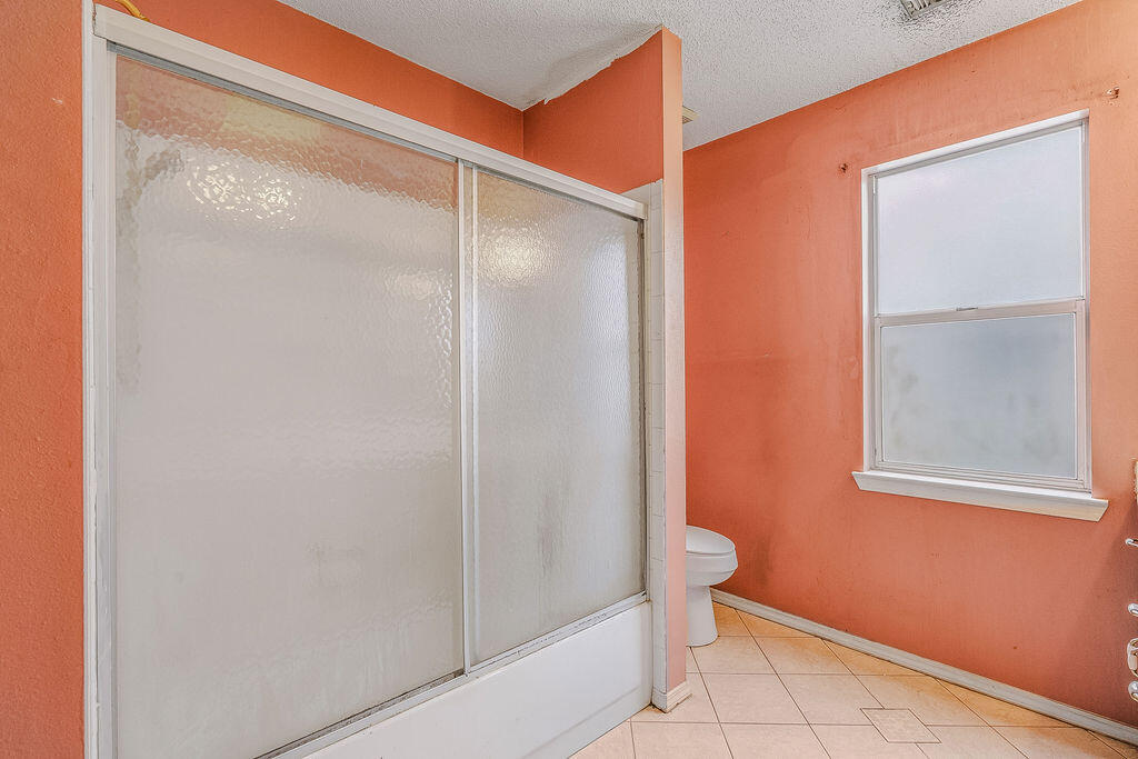 53 4th Street Shalimar, FL 32579 - Photo 28 of 47 a bathroom with a glass shower door