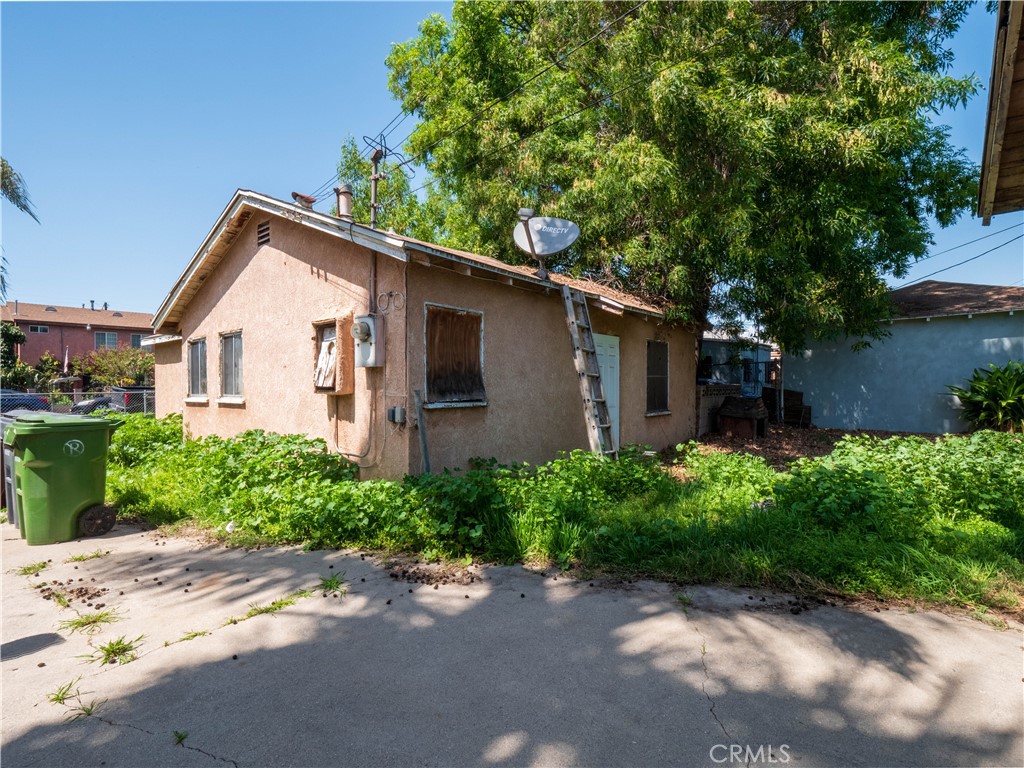 220 South Harris Avenue Compton, CA 90221 - Photo 14 of 18 a front view of a house with a yard and garage