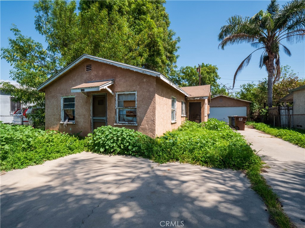 220 South Harris Avenue Compton, CA 90221 - Photo 16 of 18 a front view of a house with a yard and garage