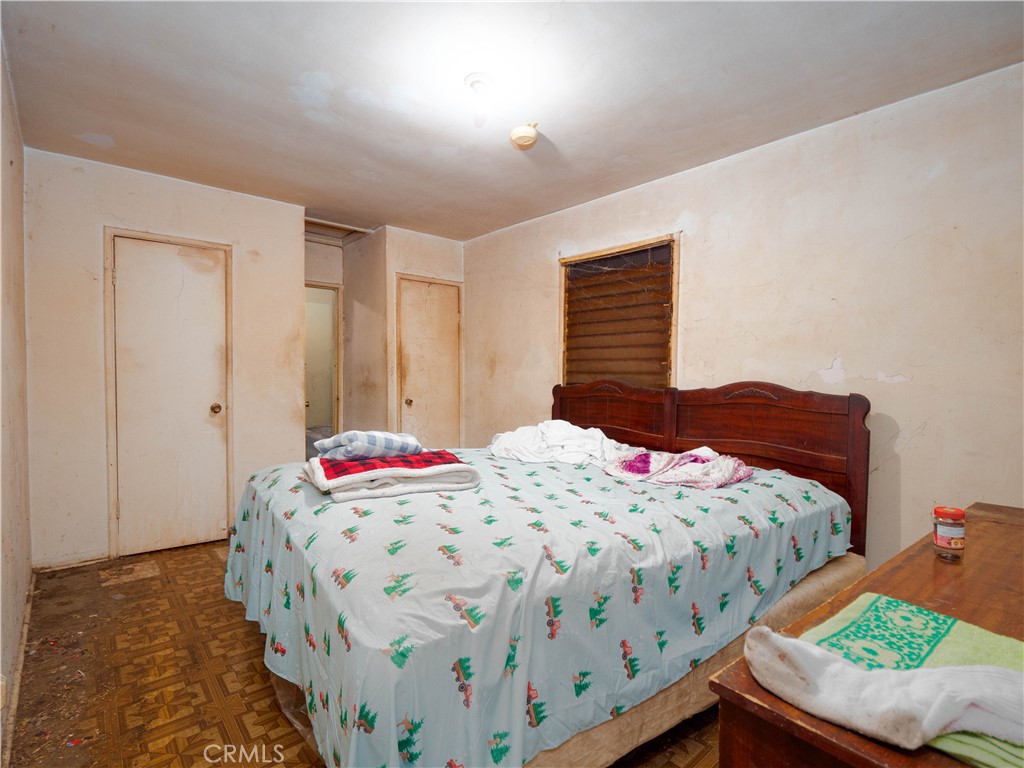 220 South Harris Avenue Compton, CA 90221 - Photo 9 of 18 a bedroom with two beds and a chandelier