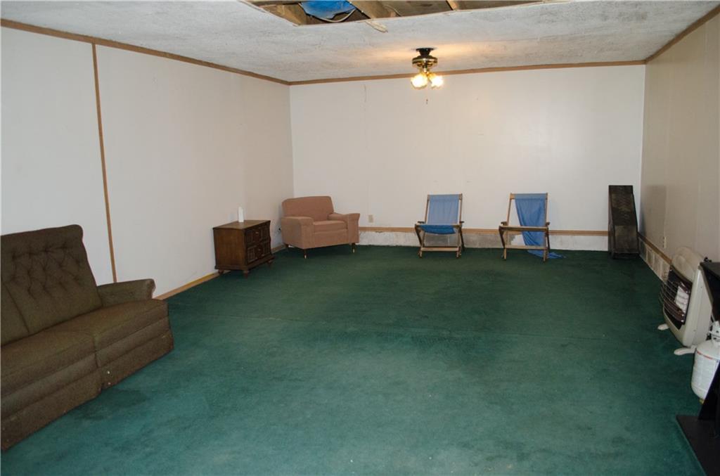 2401 Hudson Road Hudson, ME 04449 - Photo 24 of 26 Garage rec room with propane heater