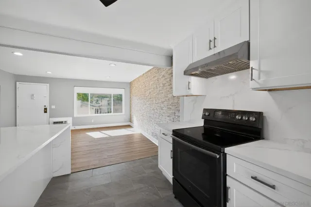 a kitchen with a stove and a refrigerator