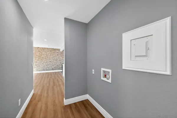 a view of an empty room with wooden floor