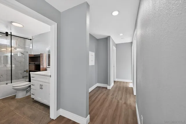 a view of a bathroom with a toilet a sink and mirror