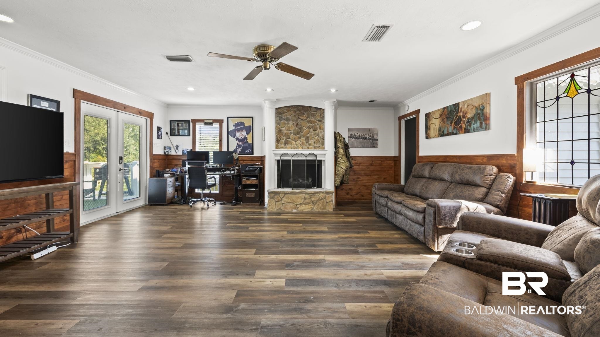 12855 Woodhaven Dairy Road West Silverhill, AL 36576 - Photo 12 of 27 Living area with an office area, crown molding, dark wood-style flooring, wainscoting, and a stone fireplace