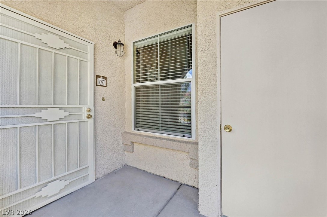 10550 West Alexander Road, Unit 1097 Las Vegas, NV 89129 - Photo 20 of 37 An arched covered entrance features a security screen door for privacy.